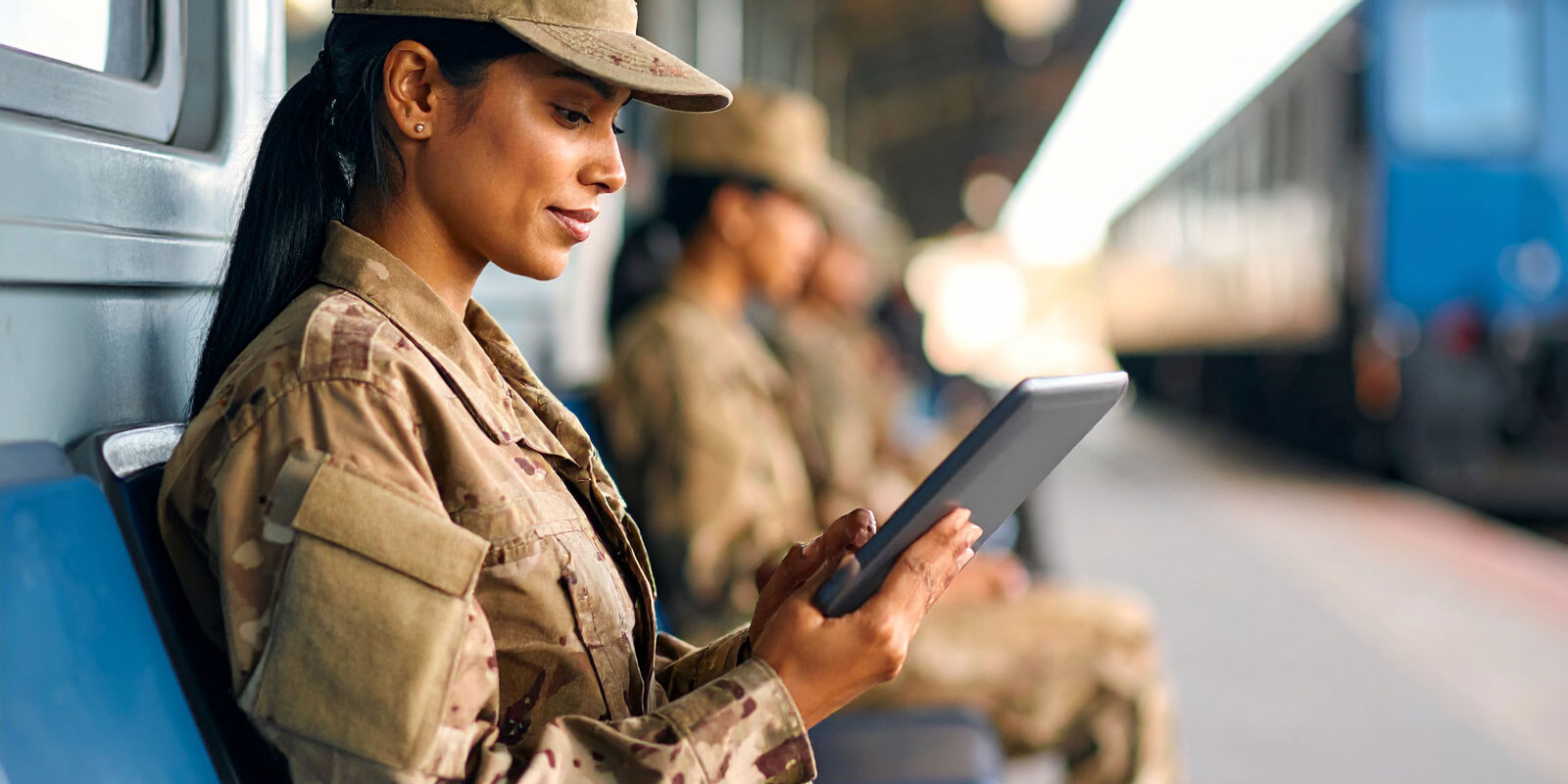 military-woman-reading-a-tablet-sitting-down